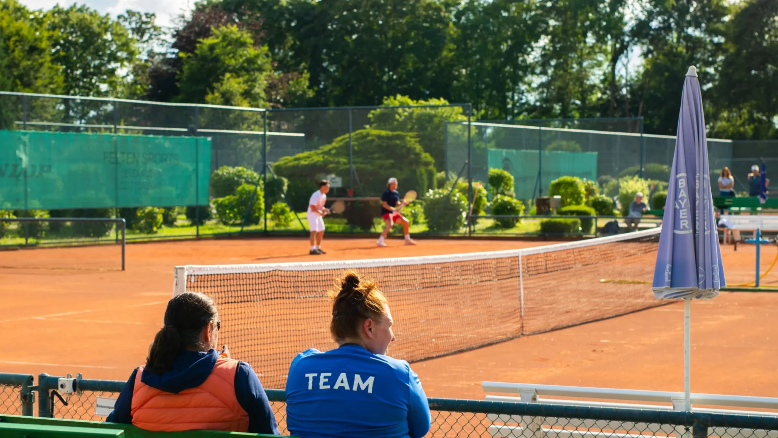 college coaches watching tennis players